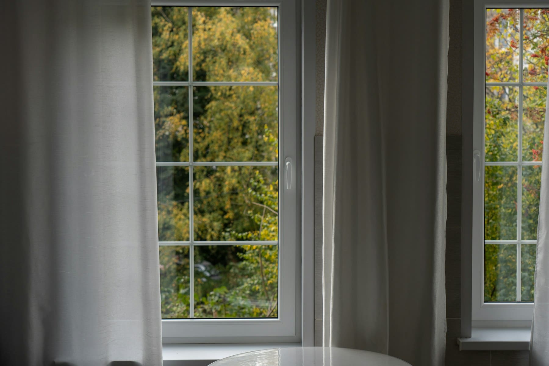 Bright, clean home interior beside a large window.